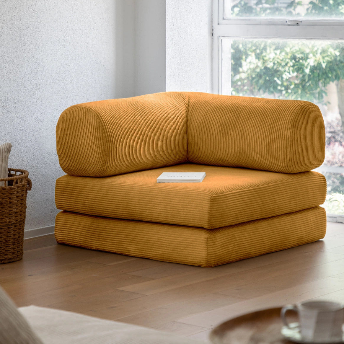 Yellow corner sofa in a living room with a window in the background